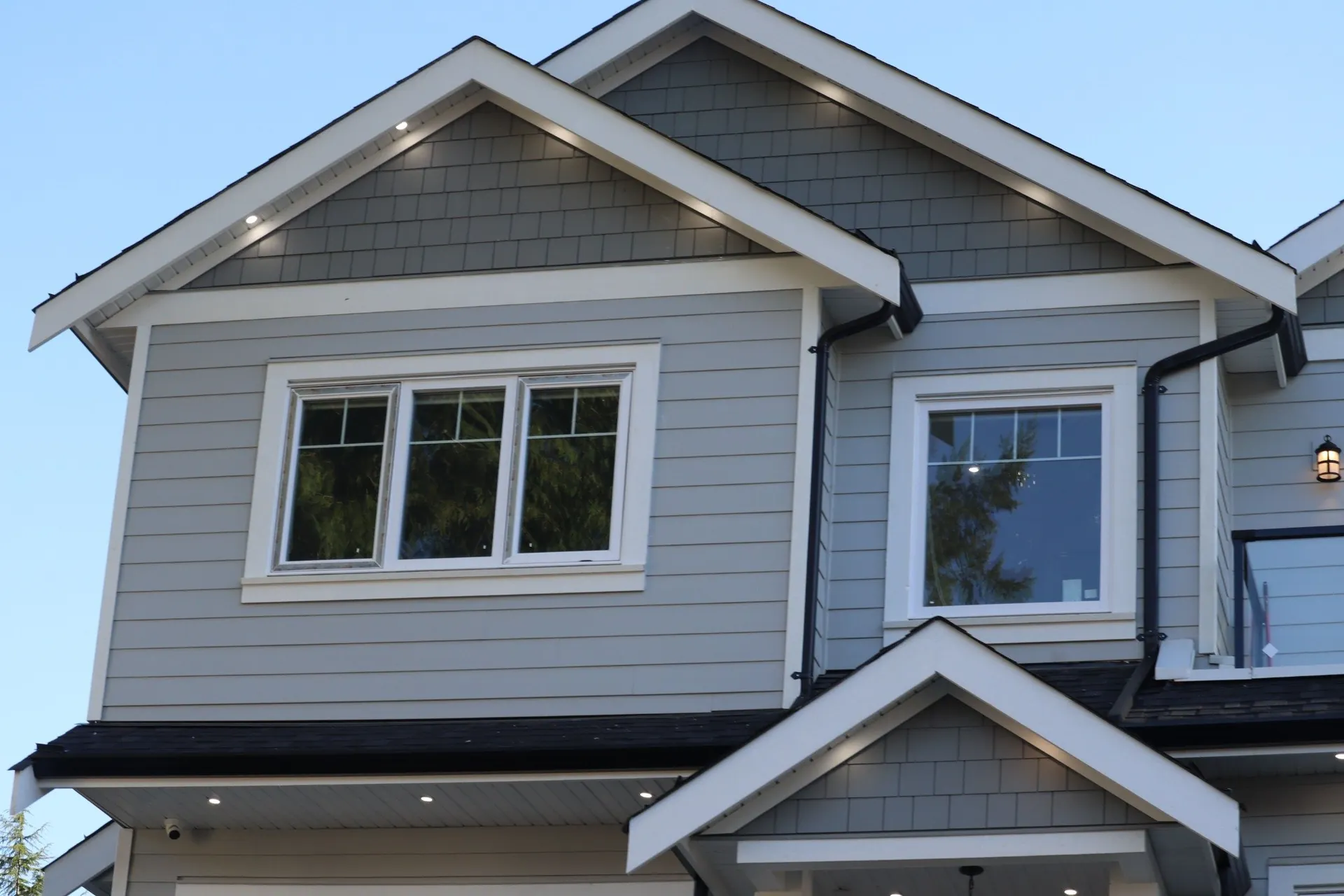 Two-story home exterior with prominent residential windows
