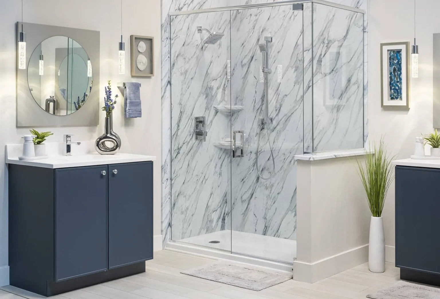 After: modern marble bathroom with blue vanities and glass shower enclosure